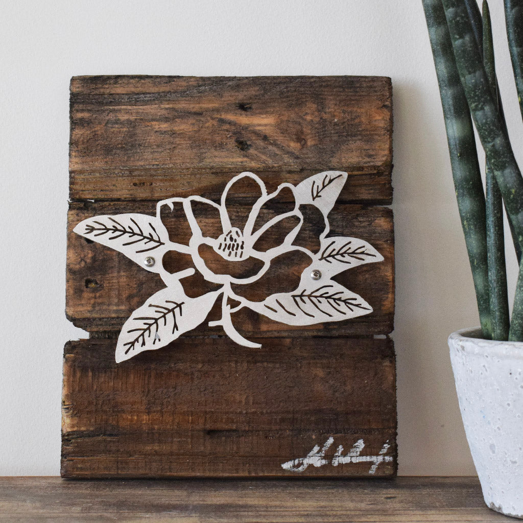 magnolia metal plaque on wooden board