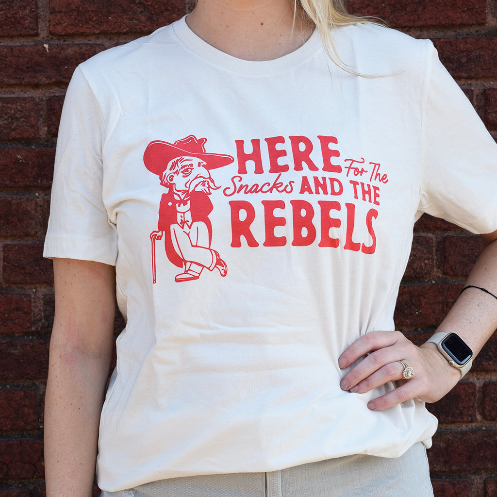 white tee shirt that says here for the snacks and the rebels